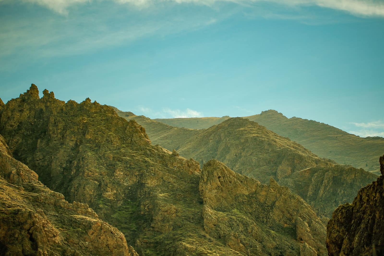 Rugged rocky hills in a valley under a clear sky