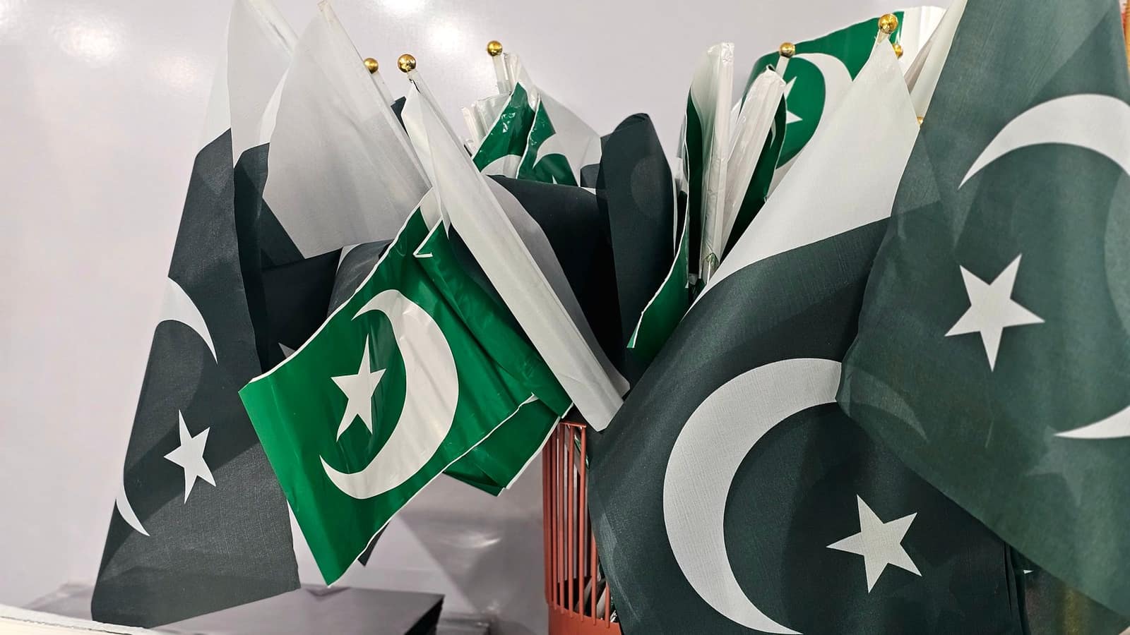 A group of Pakistani national flags displayed together indoors