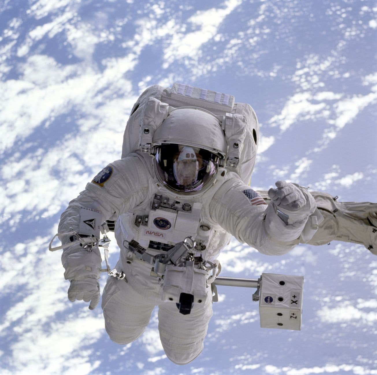 Astronaut on a spacewalk with Earth visible in the background