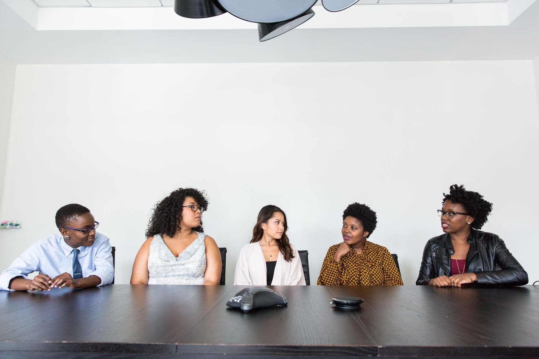 A group of professionals having a discussion in a modern office setting