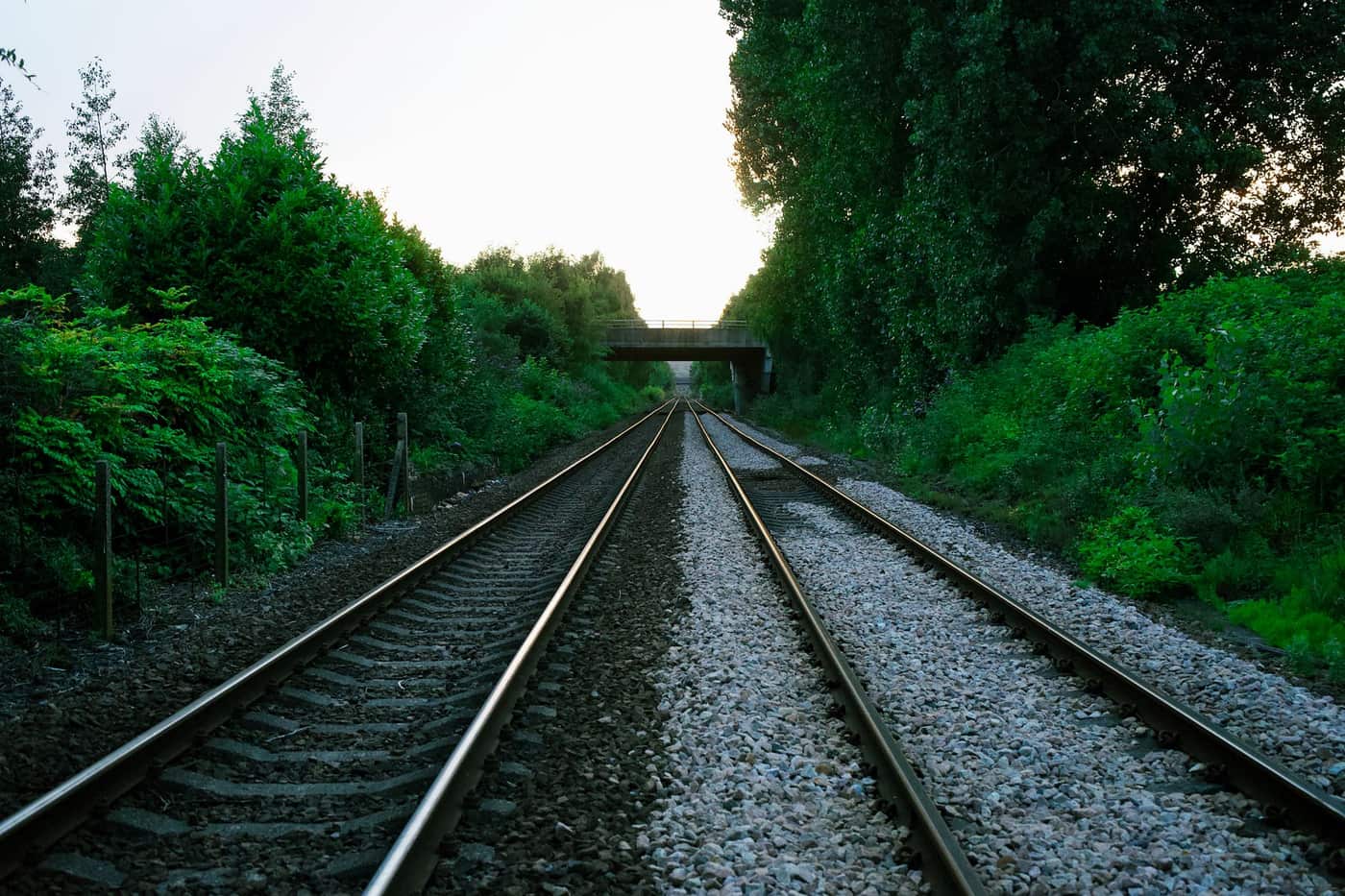Railway tracks running beneath a bridge