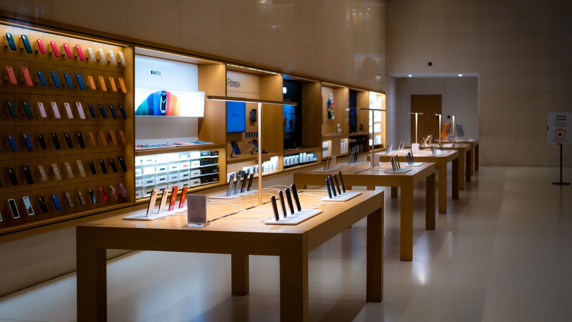 Sleek interior of a mobile phone store with devices displayed on shelves