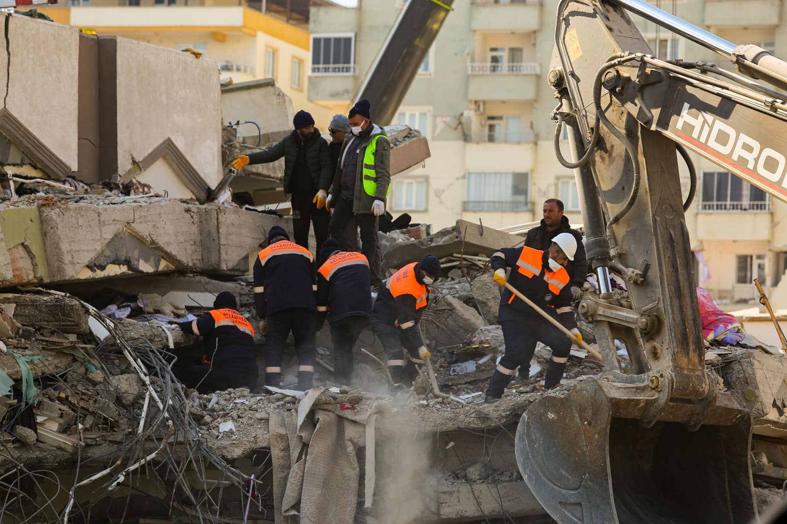 Rescue workers searching through the rubble of a collapsed building