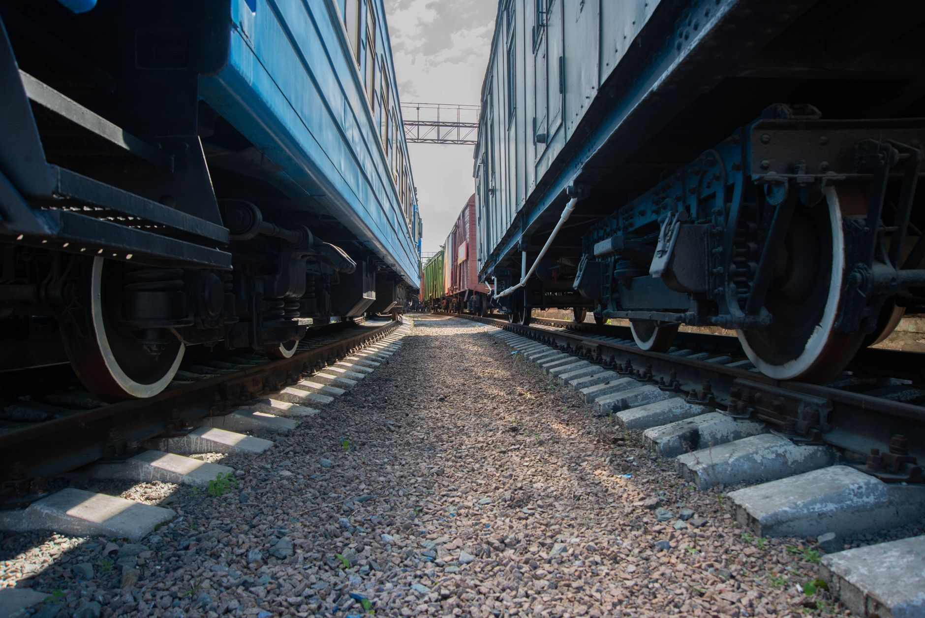 Close-up view of railway tracks running between two rail cars