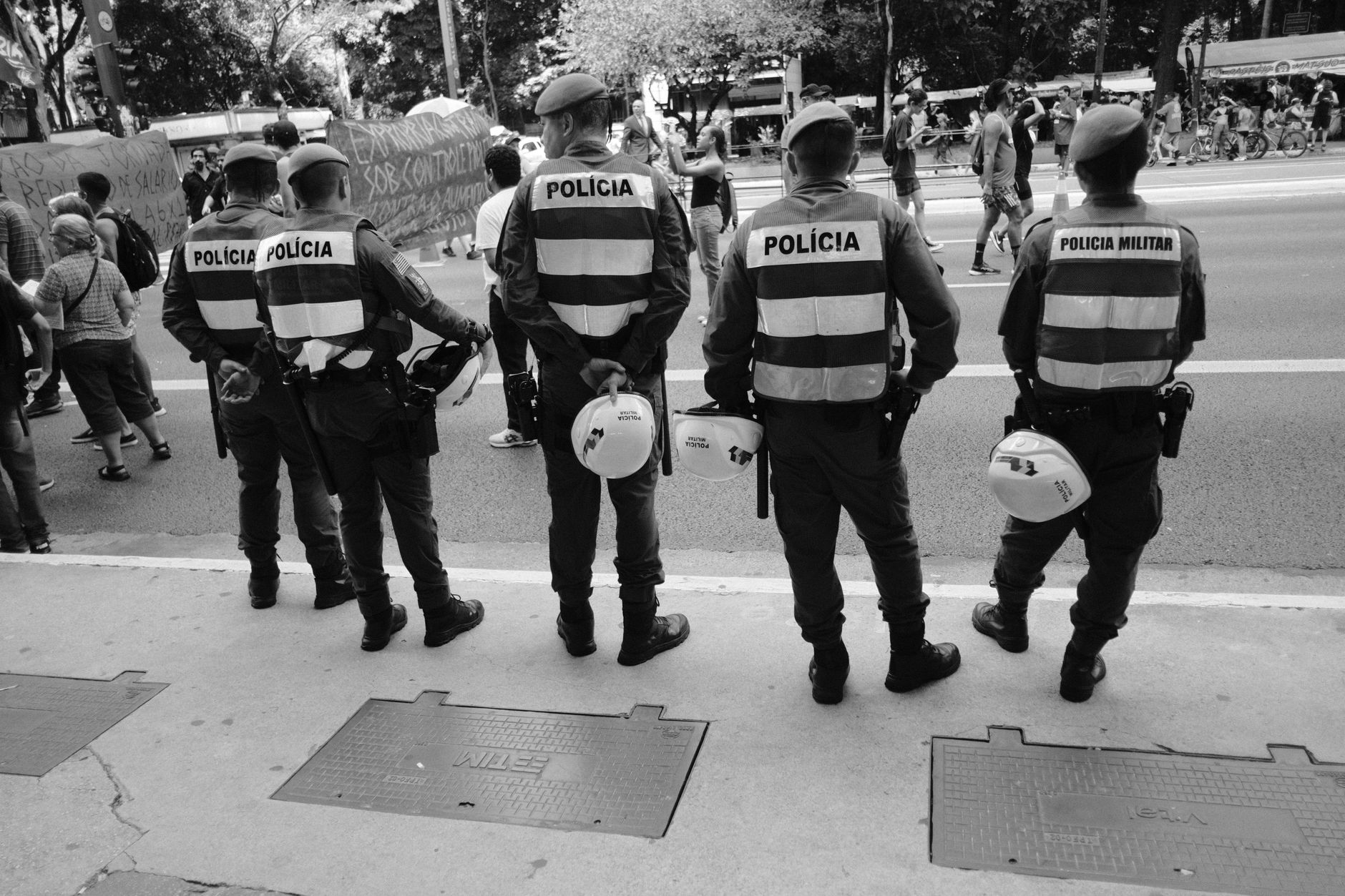 Police officers in uniform standing watch over a street during daylight