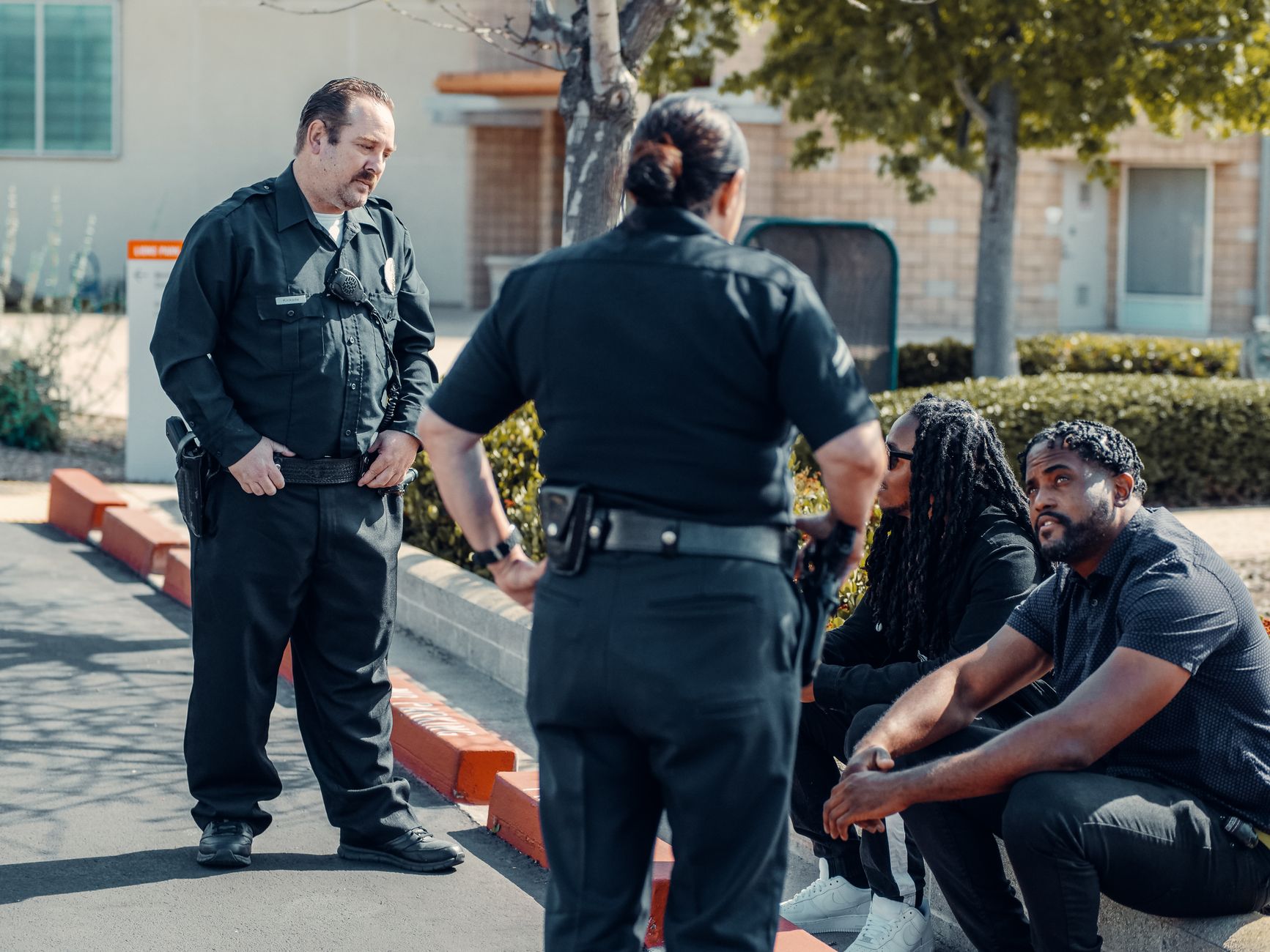 Police officers interacting with community members in an outdoor urban setting