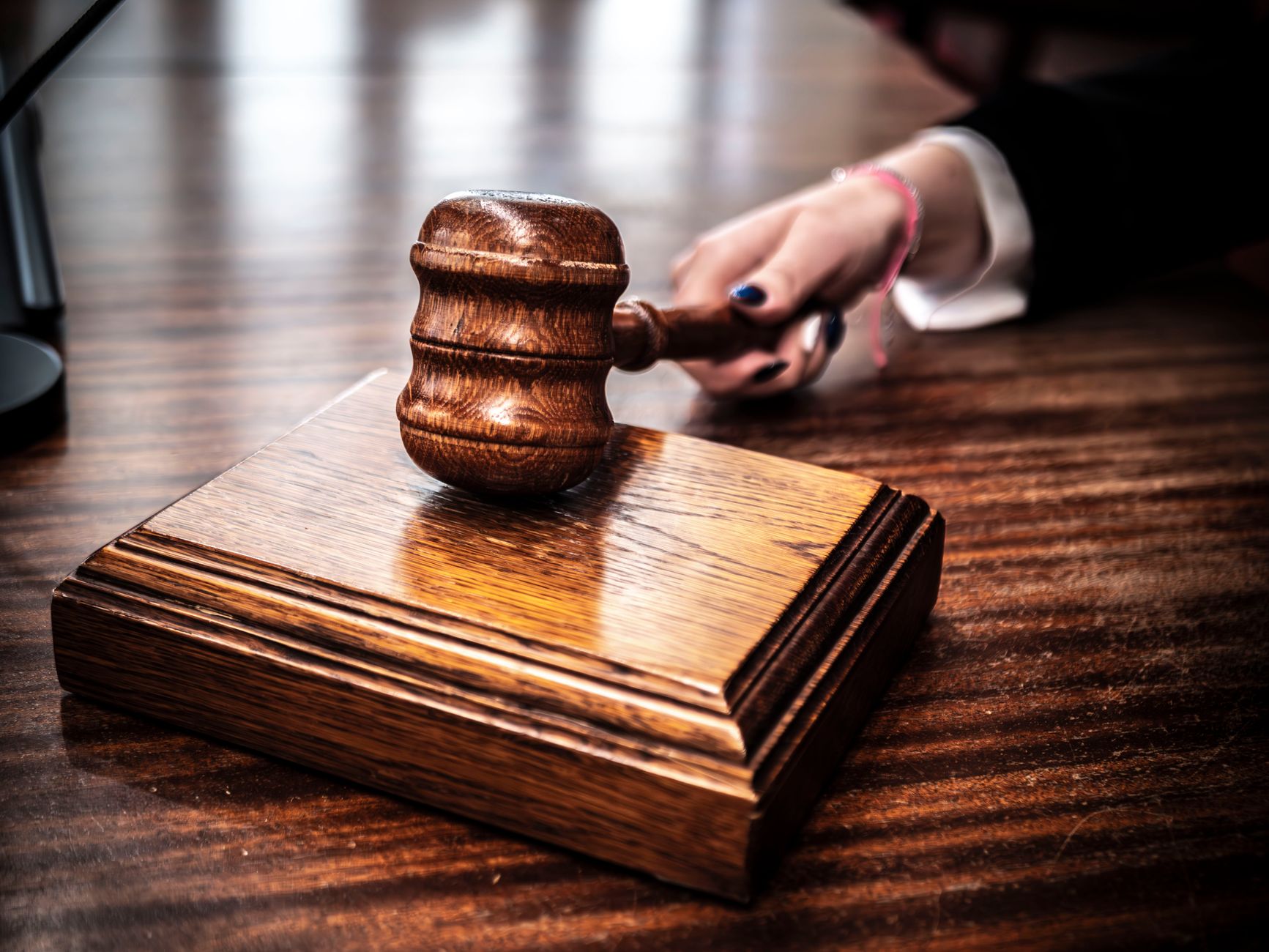 Close-up of a wooden gavel on a judge's desk