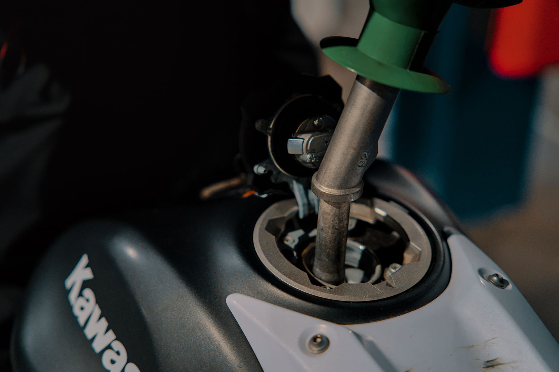 Close-up of a motorcycle being refueled at a gas station