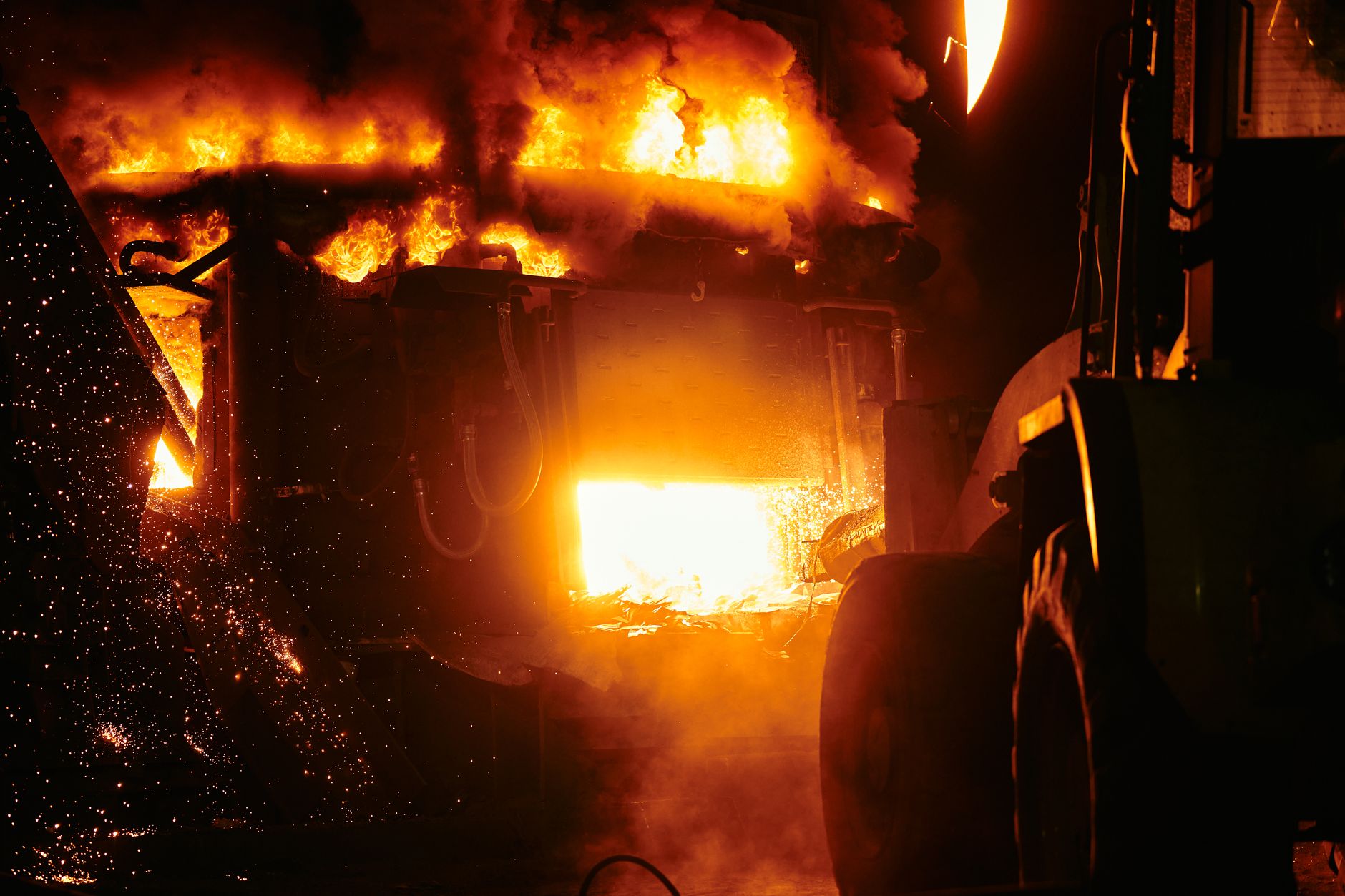 Close-up of an industrial furnace emitting intense flames