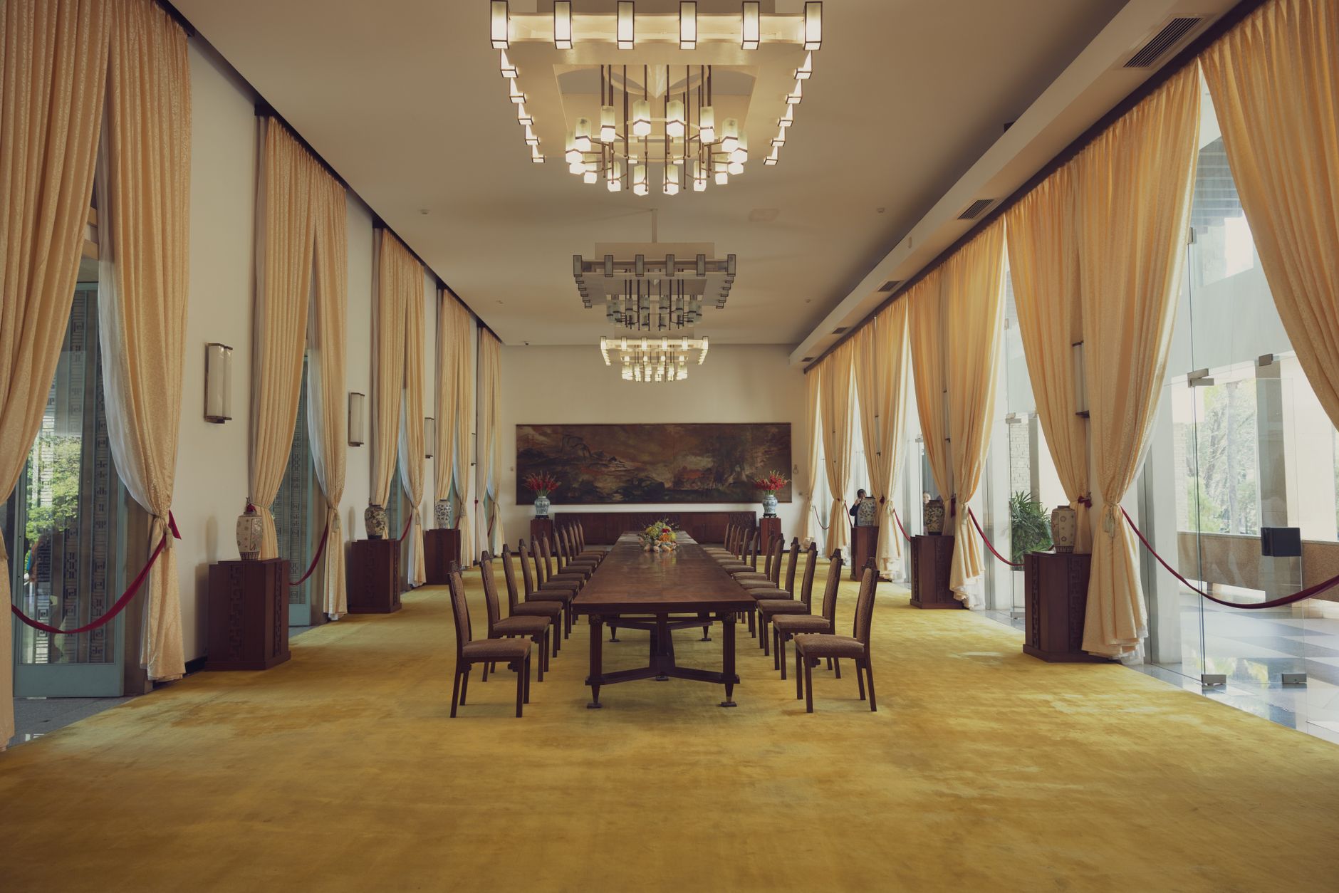 A large, empty modern conference room set up for a multilateral meeting