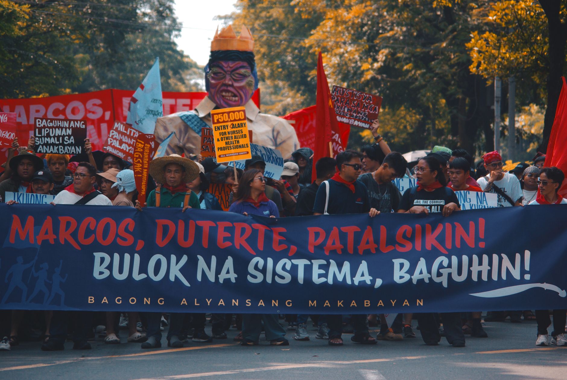 Street protest with demonstrators holding banners and signs