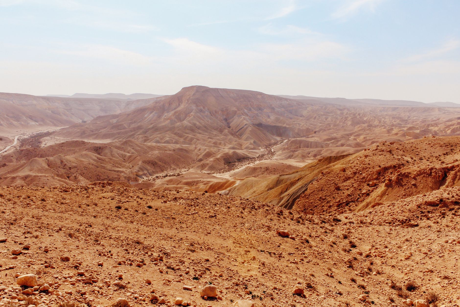 A vast and arid mountainous desert landscape under a clear blue sky