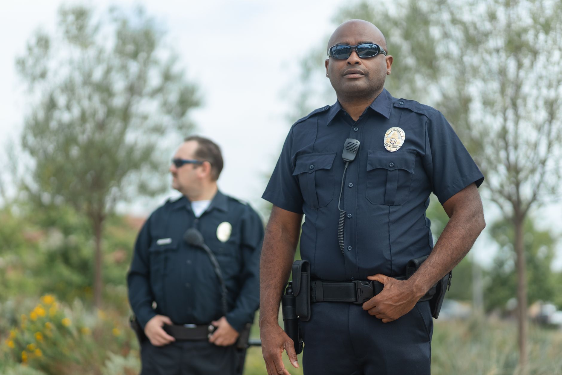Two police officers in uniform standing outside