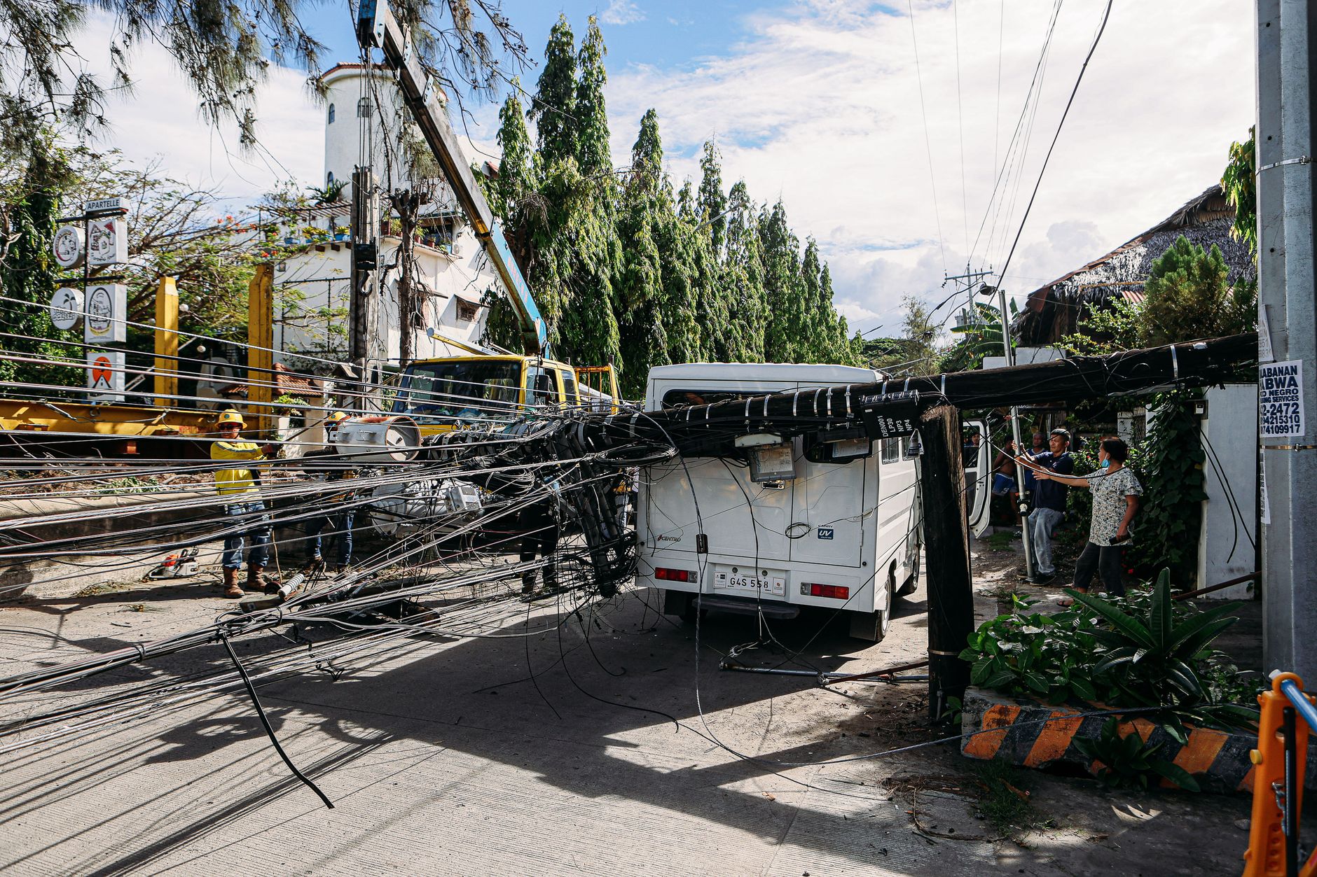 Utility crew working on power lines on a city street
