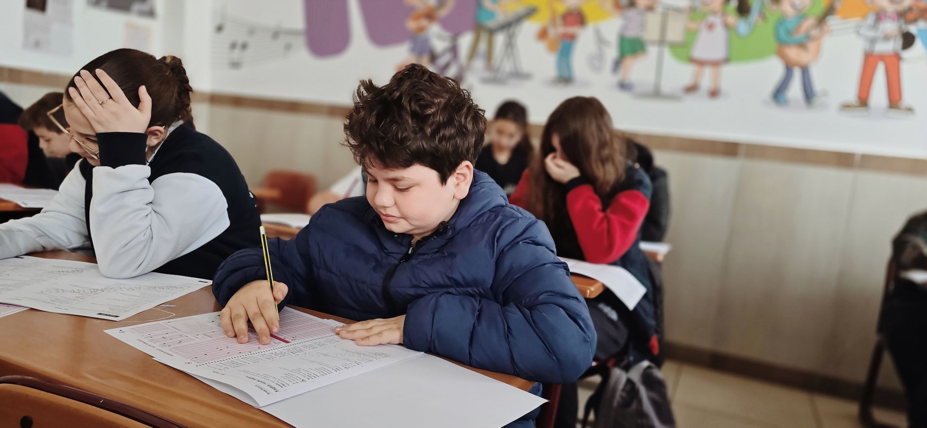 A group of children taking a test with focus and concentration in a classroom setting