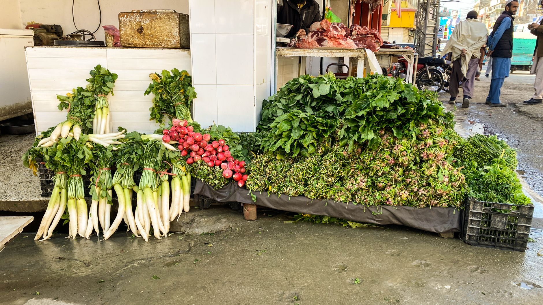 A variety of fresh vegetables on display at an outdoor market stall in Mingora, Pakistan