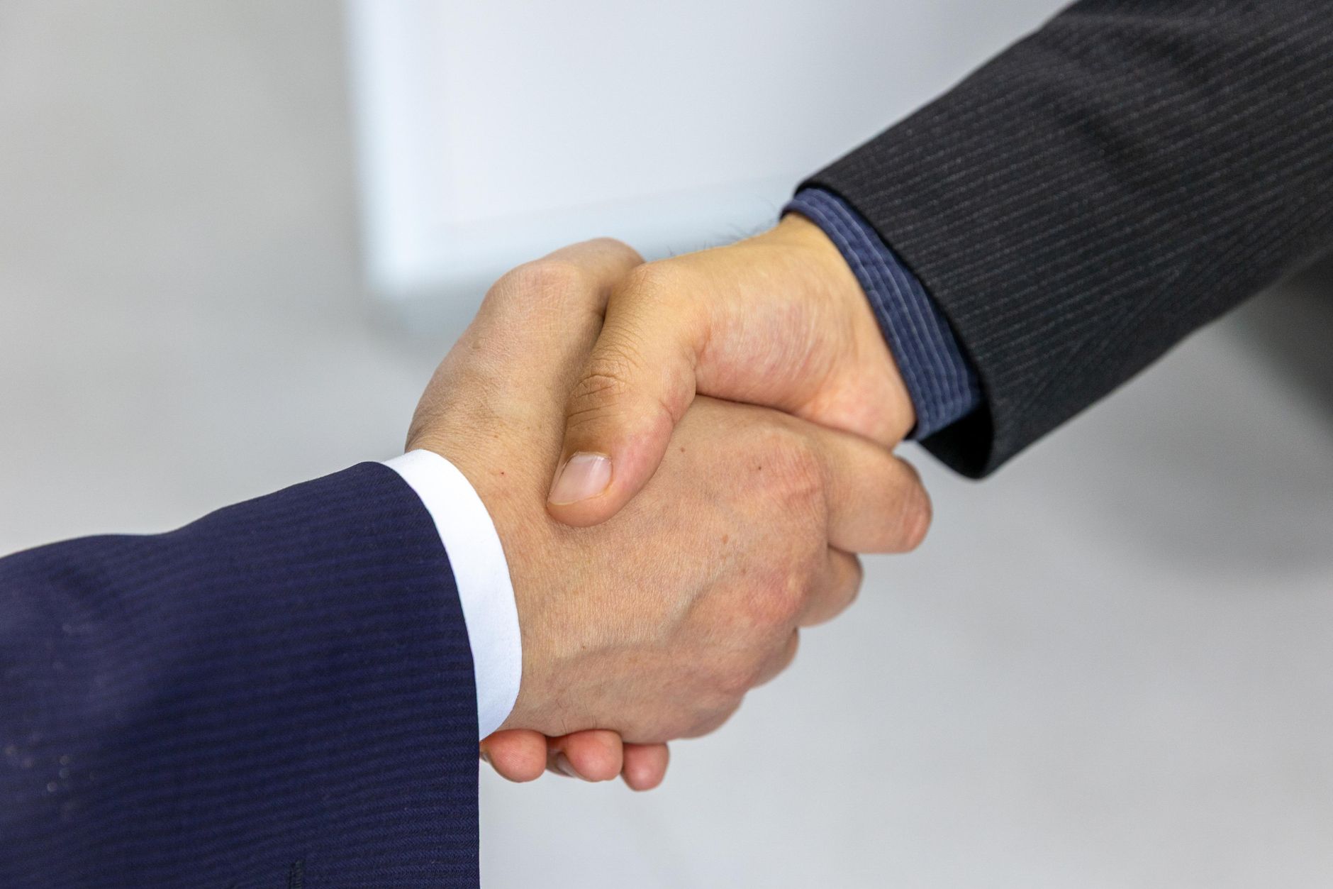 Close-up of two businessmen shaking hands, symbolizing agreement and partnership
