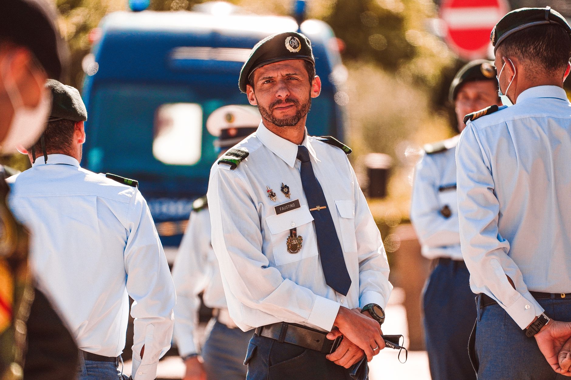 A group of uniformed officers gathered outdoors for a meeting