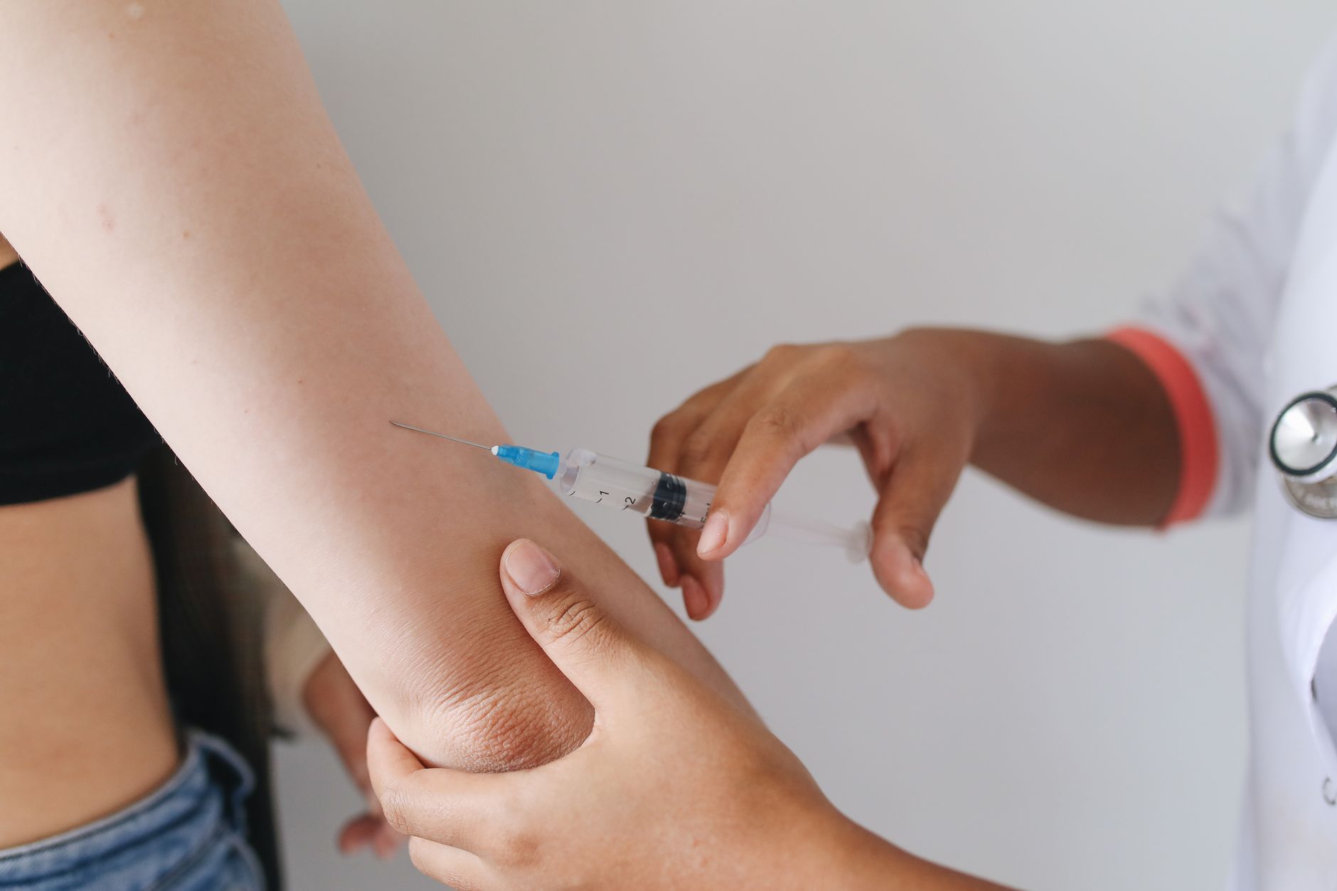 Close-up of a doctor administering an injection to a patient's arm