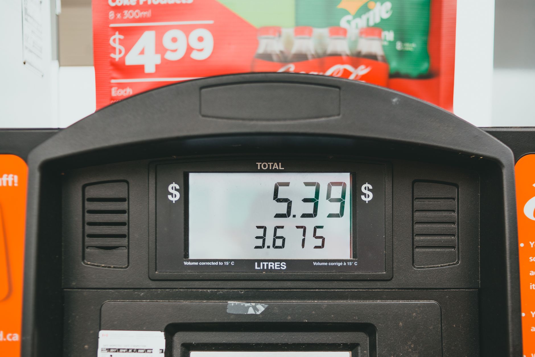 Close-up of a fuel pump display showing the price per litre during a refuelling transaction