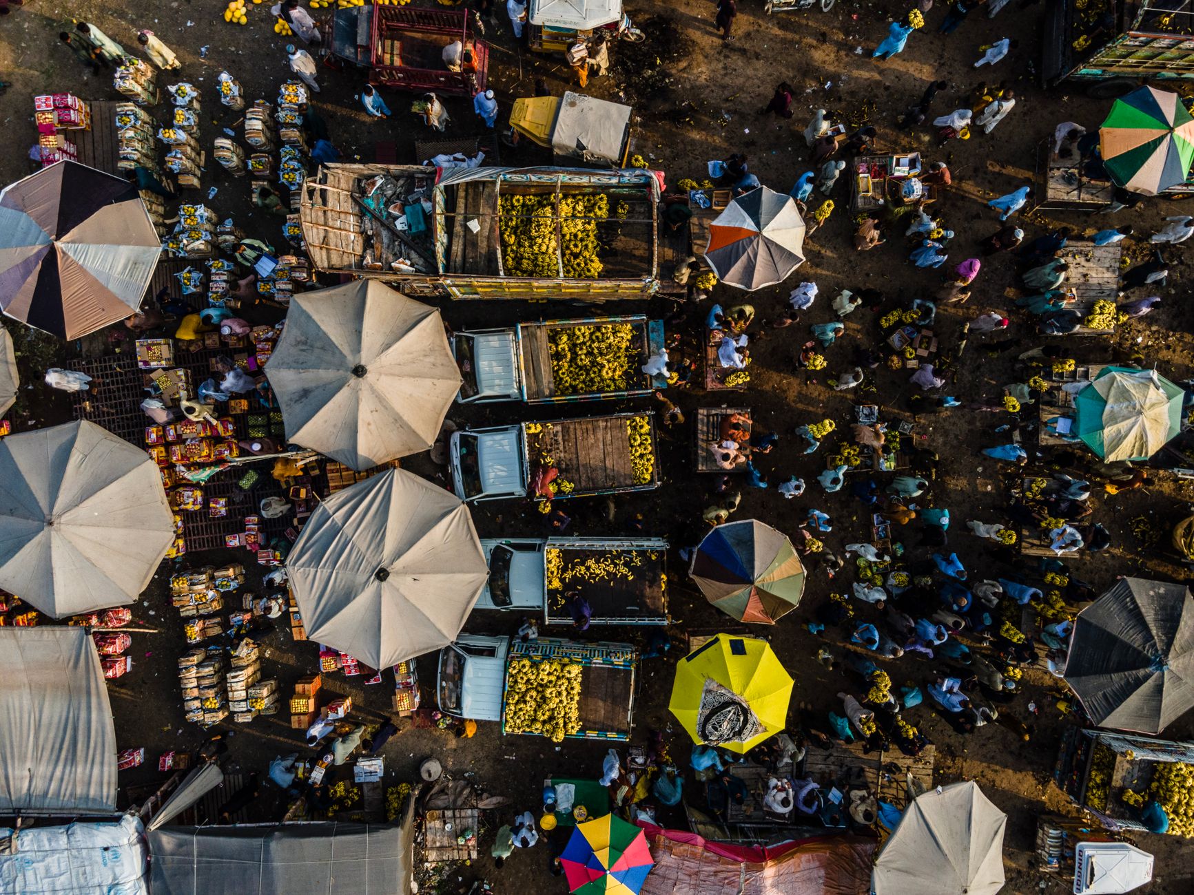 An aerial view of a crowded outdoor fruit and vegetable market